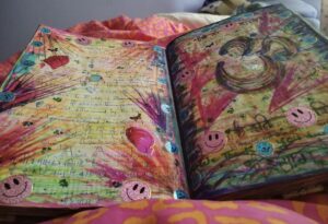 Large book, open to show two of the pages with colourful writing and pictures